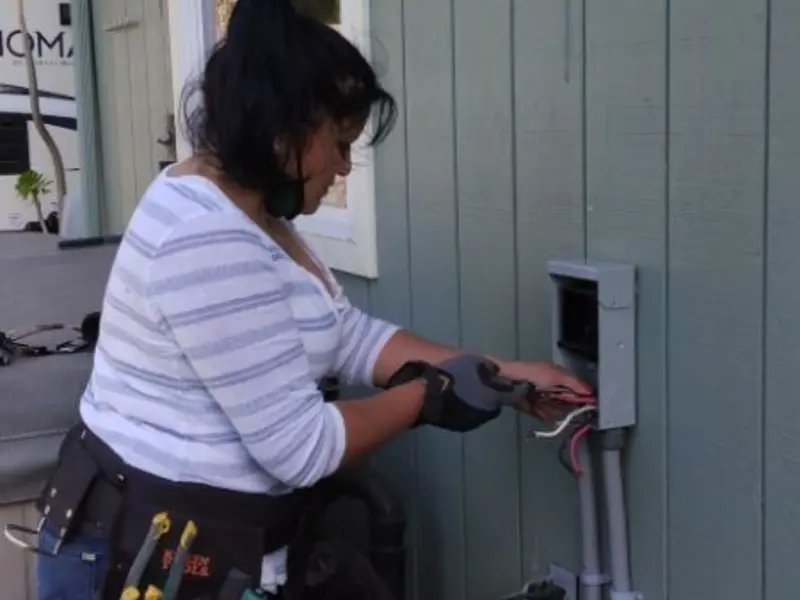 Licensed electrician wiring an exterior subpanel in Desert Edge